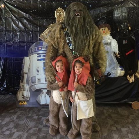 Photo of Chewbacca and two children dressed as ewoks