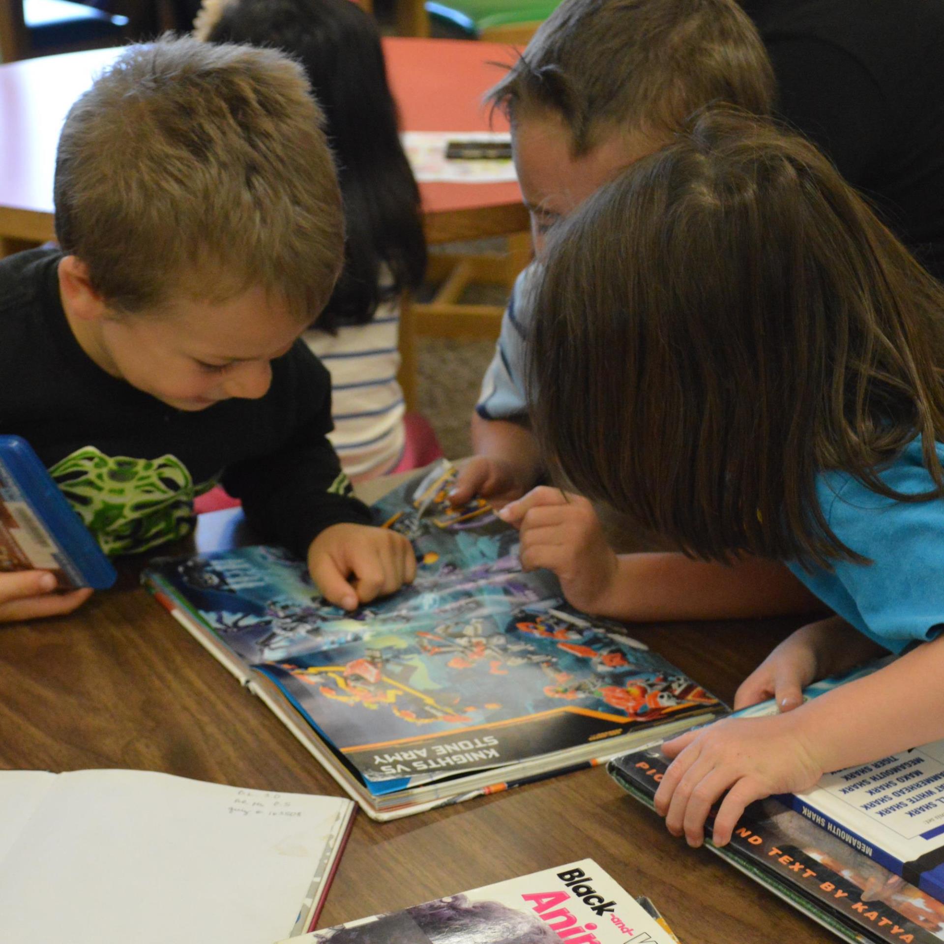 Photo of children reading a book together